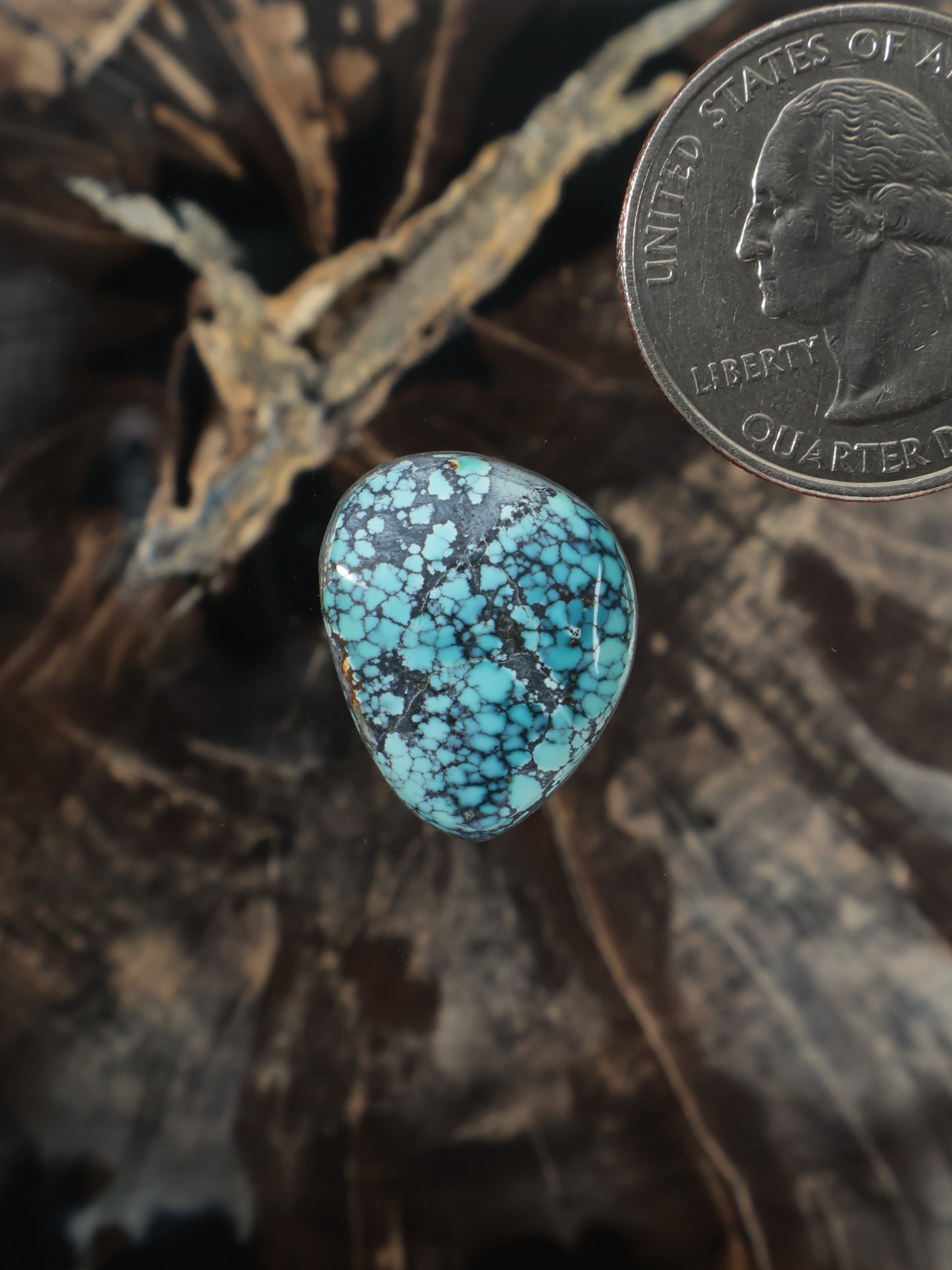 Turquoise oval cabochon gemstone with blue matrix speckles