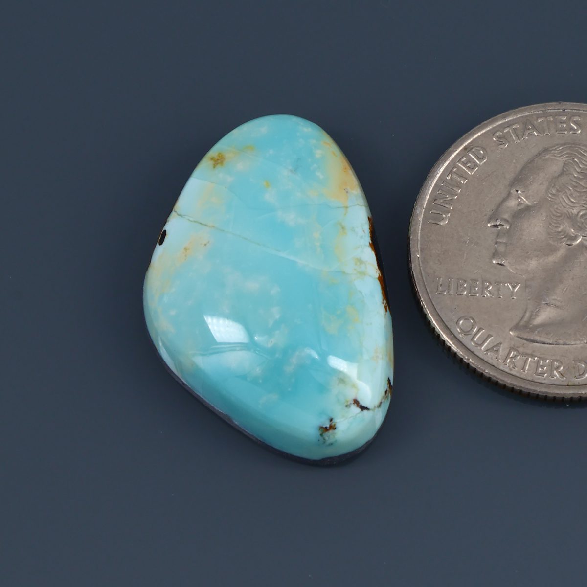 Turquoise cabochon with oval teardrop shape and natural veining