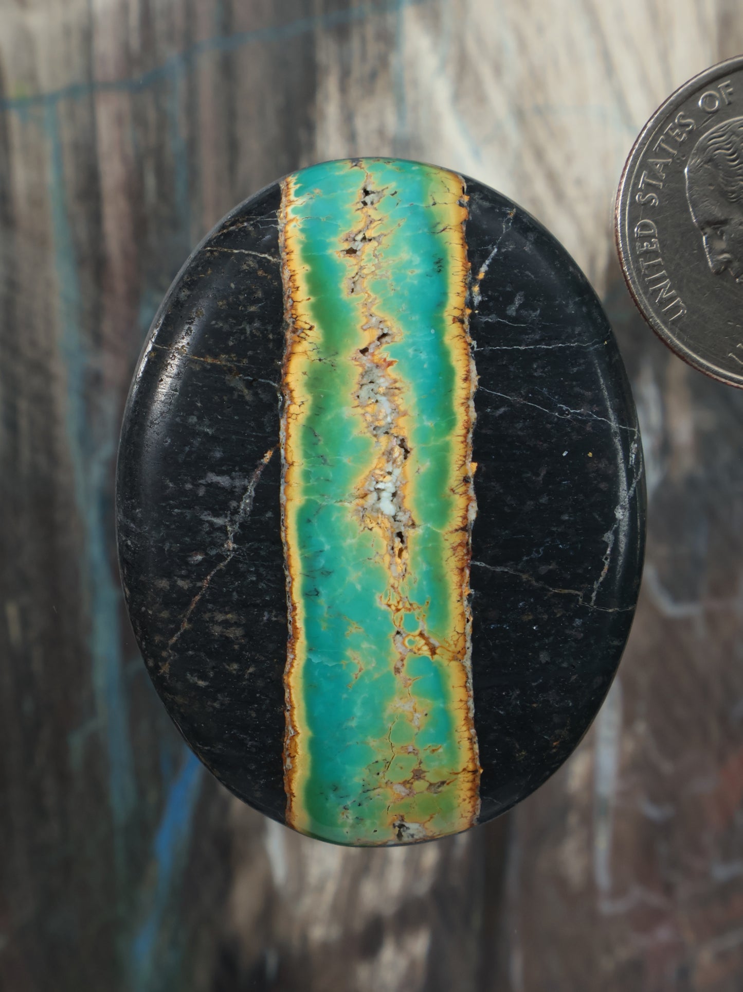 Turquoise and black cabochon gemstone with vertical striped turquoise slab