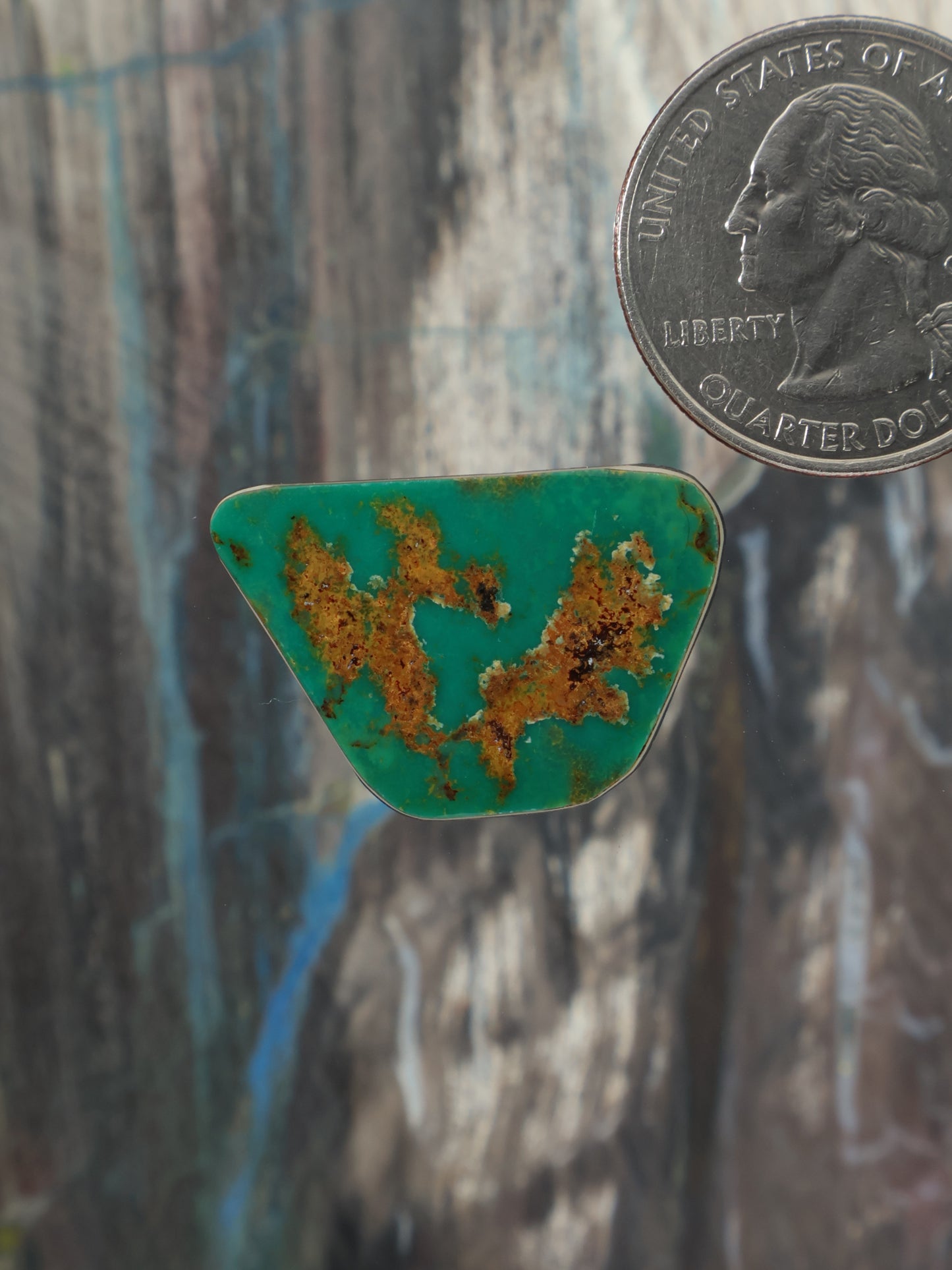 Triangular turquoise cabochon gemstone with brown matrix