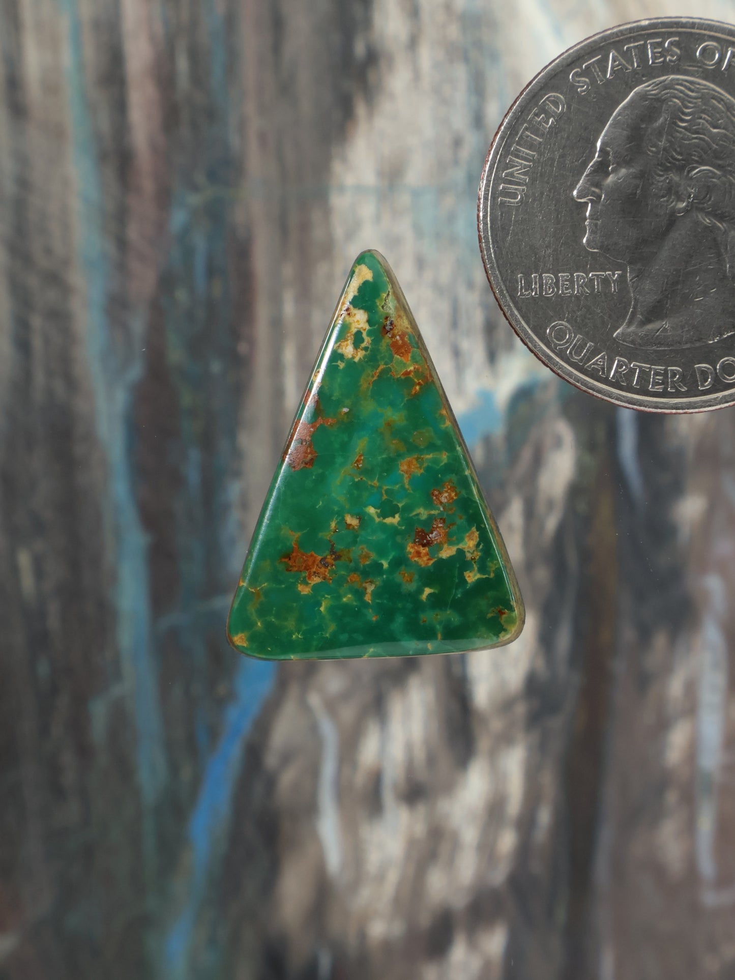 Triangular green turquoise cabochon with speckled matrix