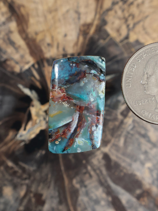 Turquoise chrysocolla chalcedony cabochon with coppery red-brown veining, rounded rectangle