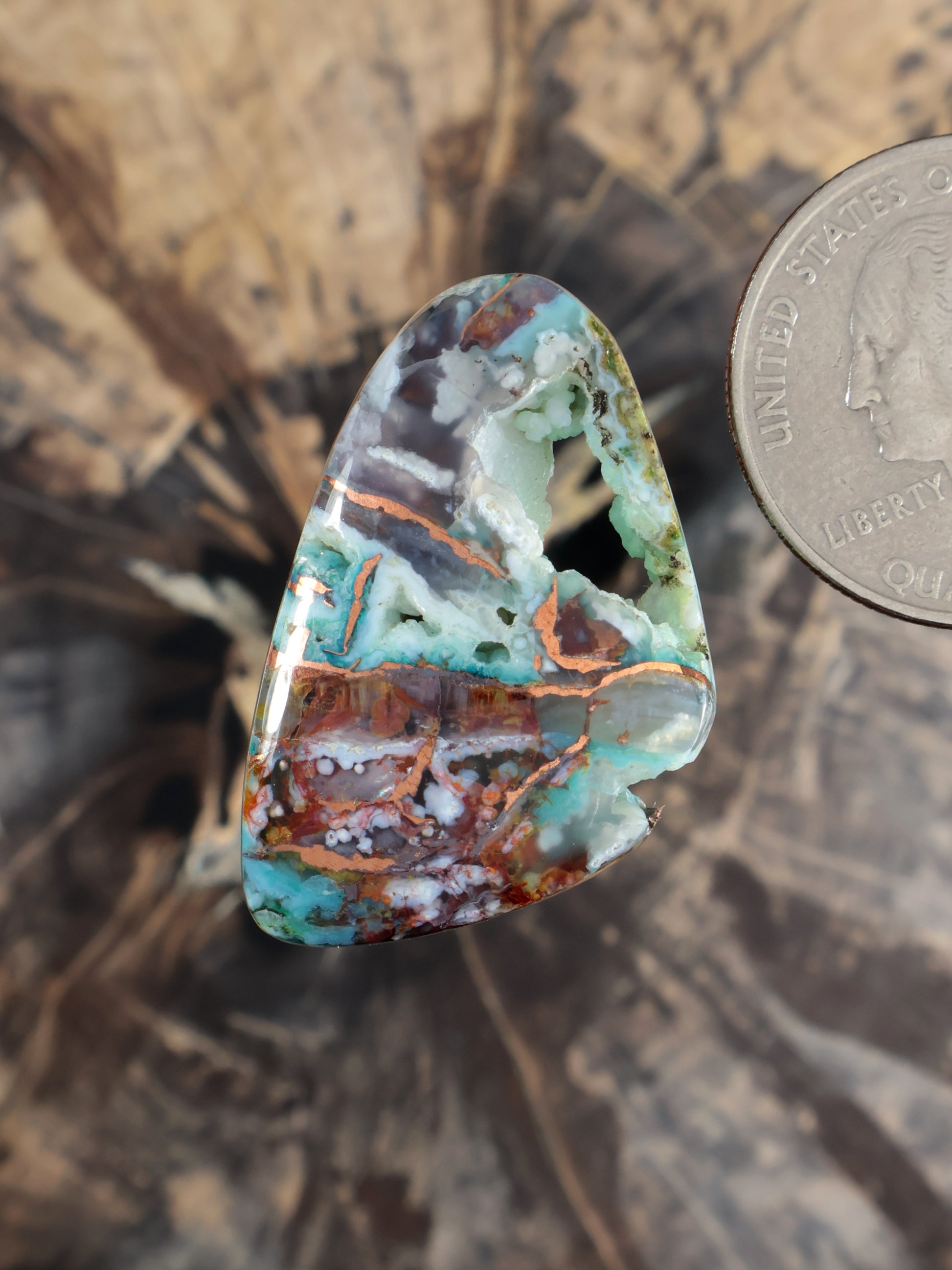 Multicolor teardrop cabochon gemstone with green, turquoise, and copper-brown bands