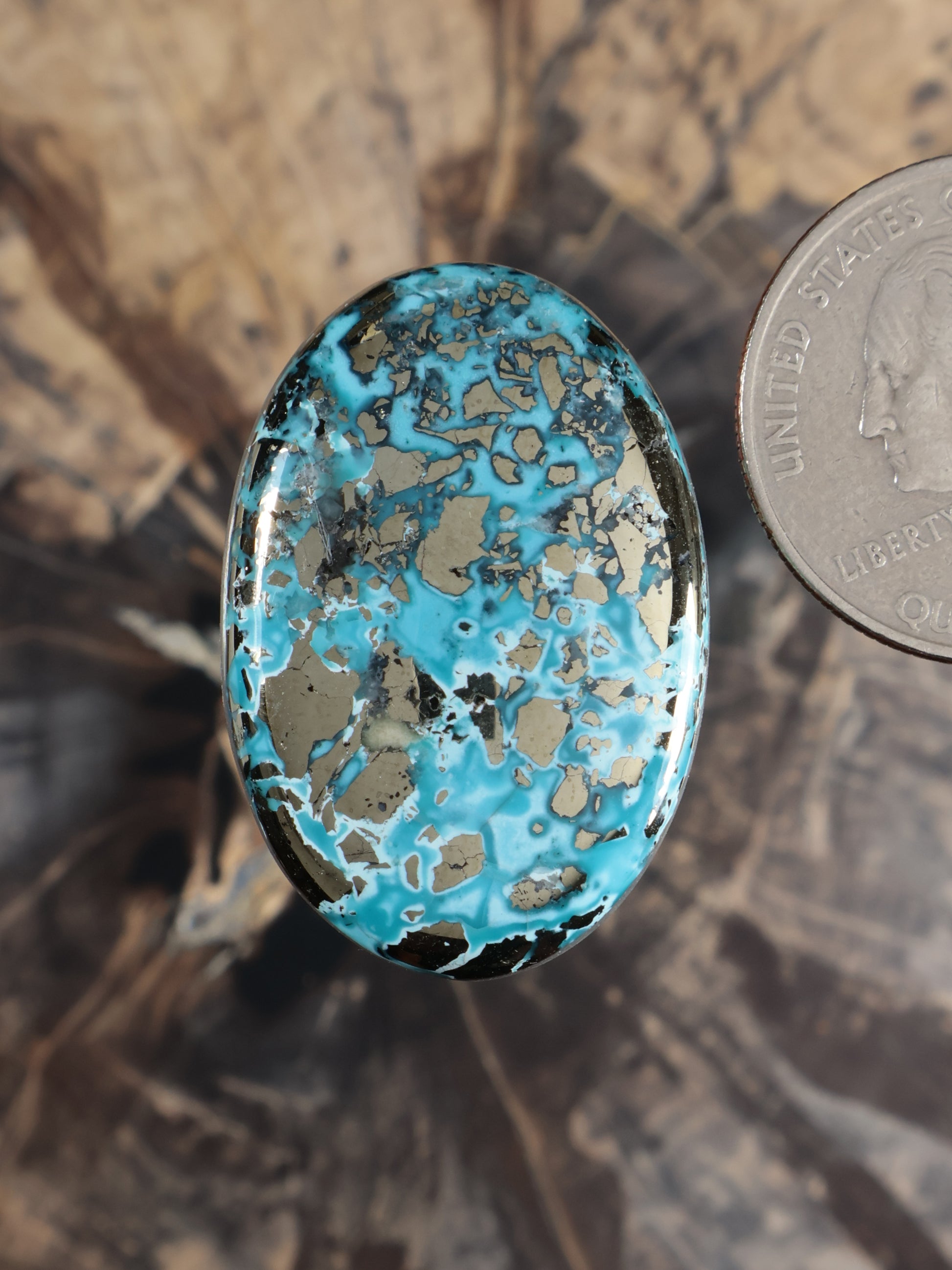 Blue turquoise oval cabochon gemstone with natural speckled pattern