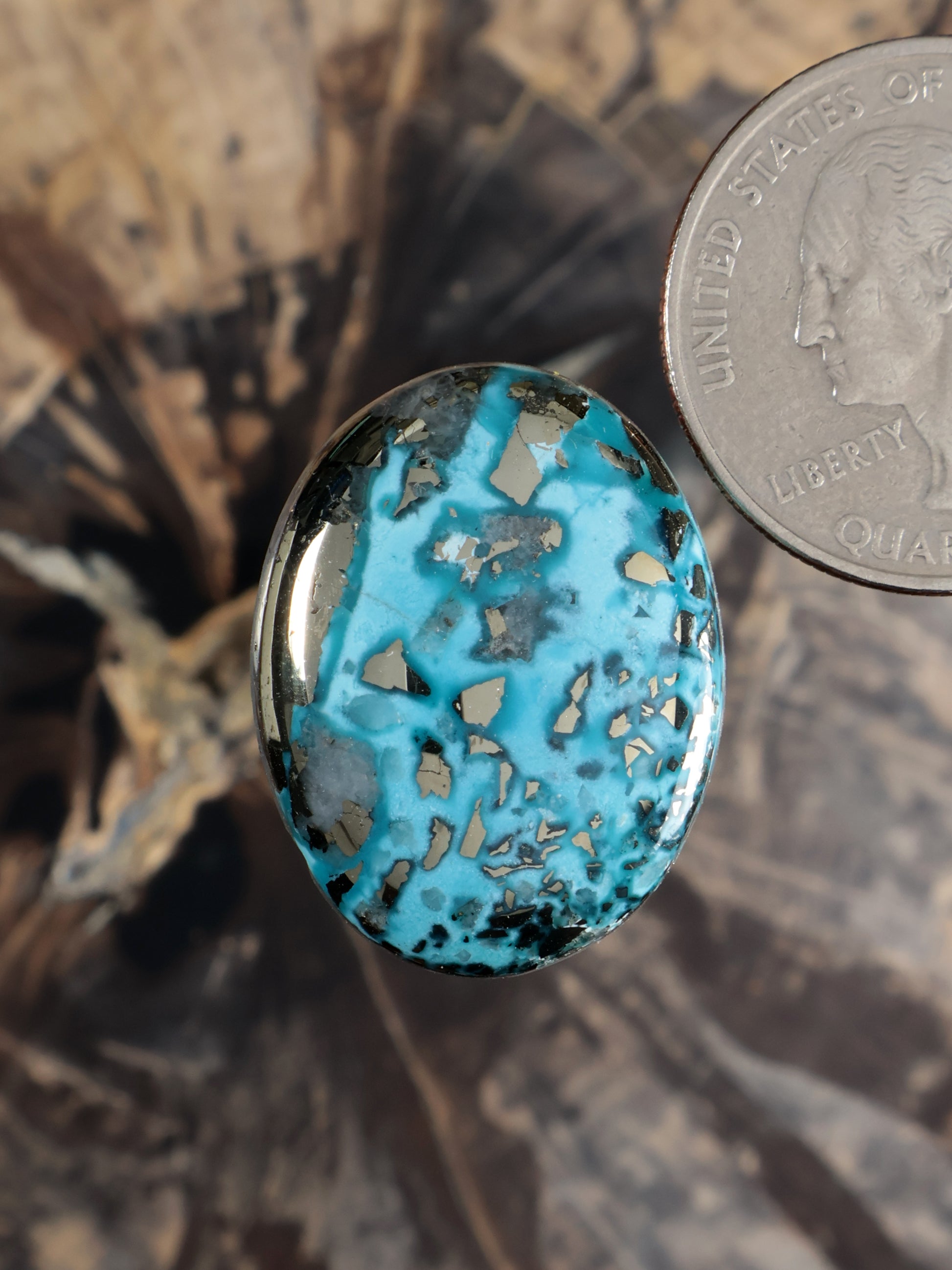 Blue turquoise cabochon gemstone, oval with dark matrix, silver bezel