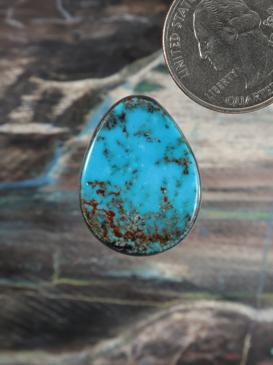 Teardrop turquoise cabochon with blue stone and brown matrix, silver-toned bezel