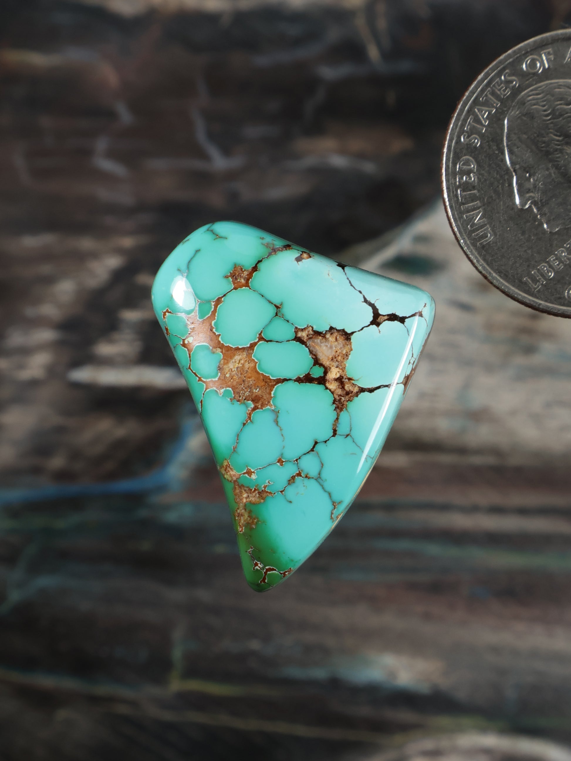 Turquoise cabochon gemstone with brown matrix, triangular polished stone