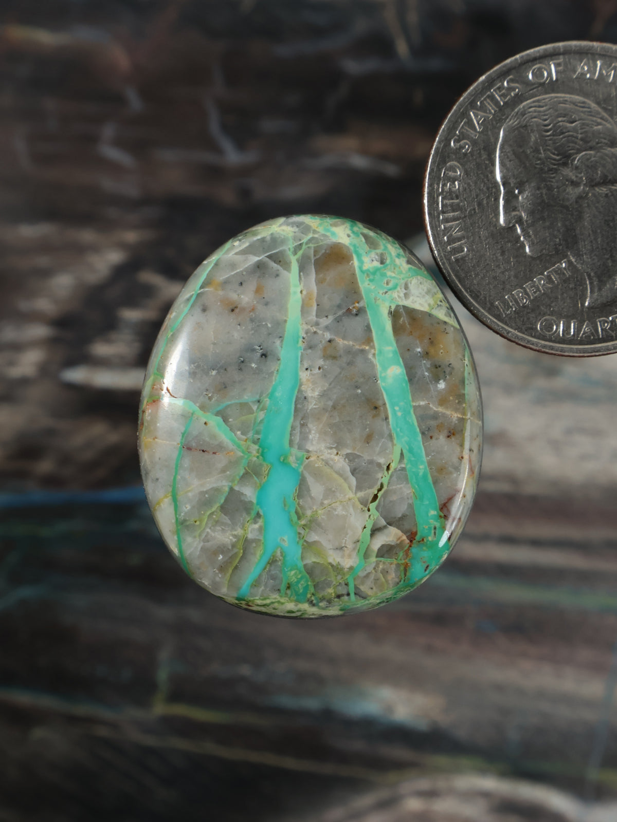 Oval ribbon turquoise cabochon with white matrix and teal streaks