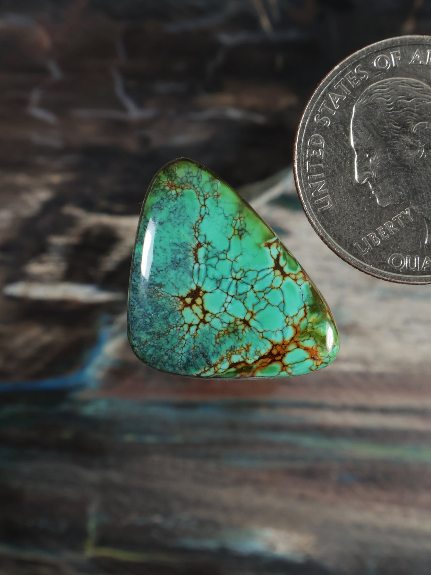 Skyhorse turquoise cabochon gemstone, pear-shaped with webbed brown matrix