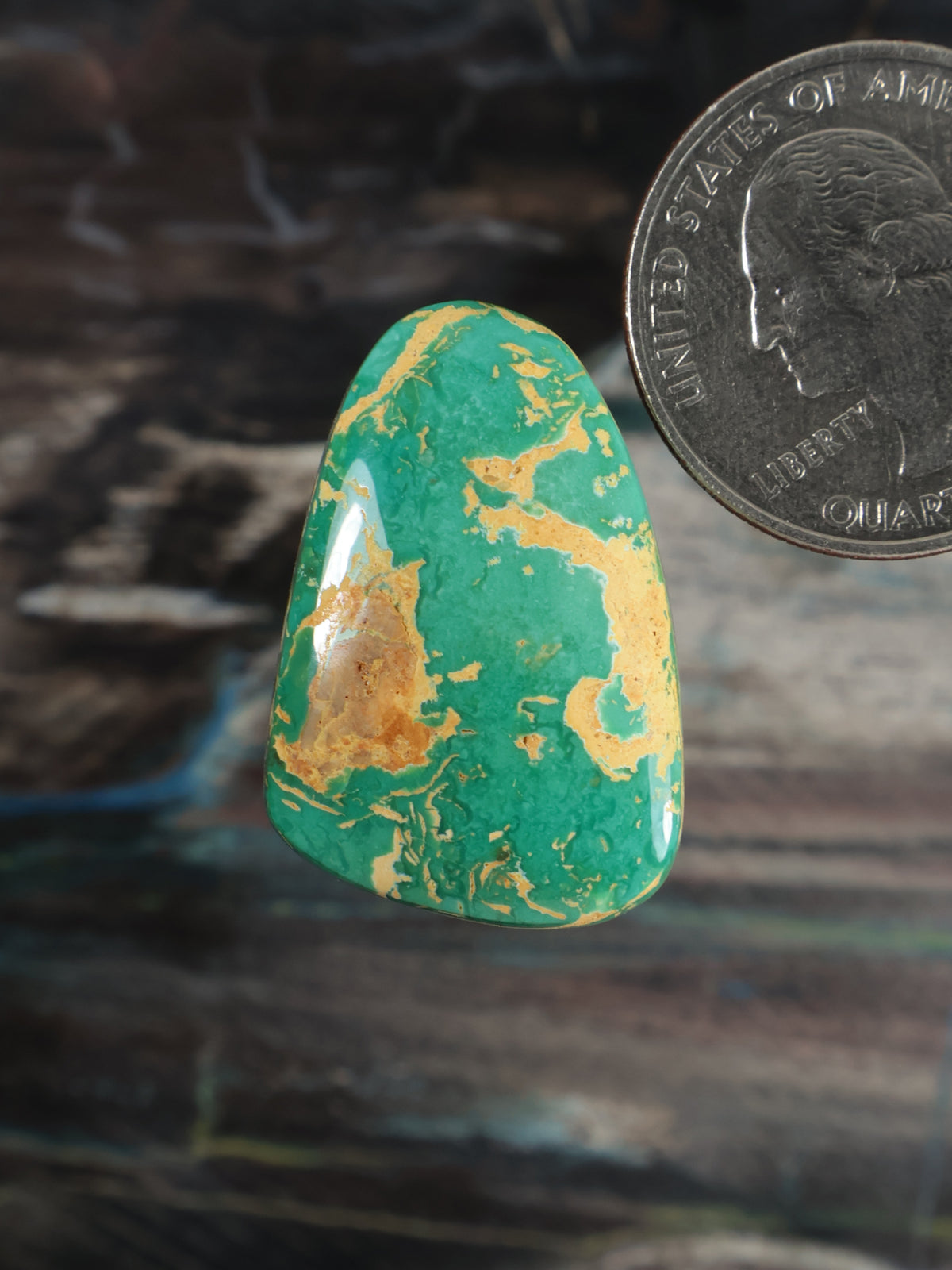 Turquoise cabochon gemstone with gold-brown matrix, oval shape