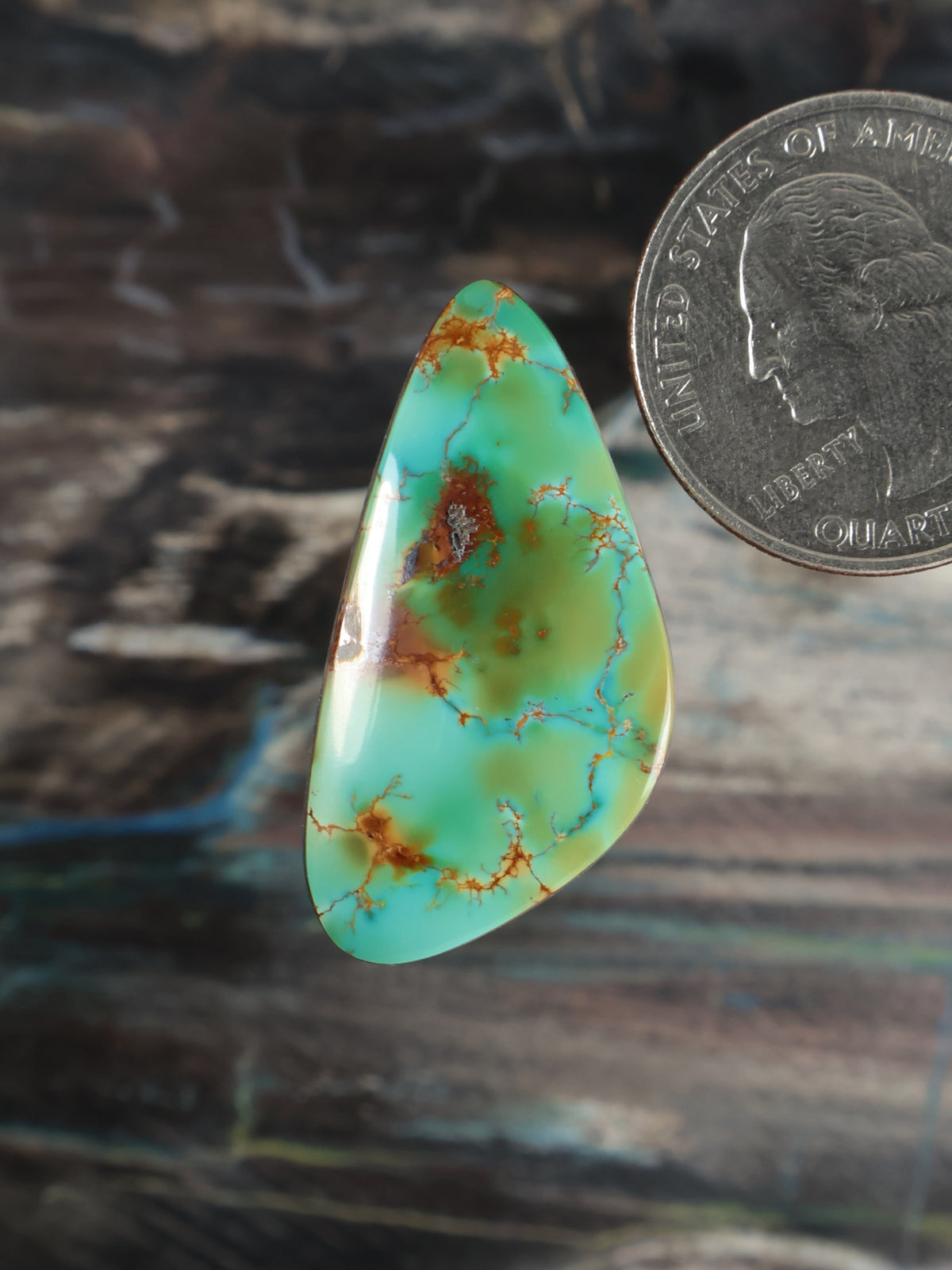 Turquoise cabochon gemstone with green veining, teardrop drop shape