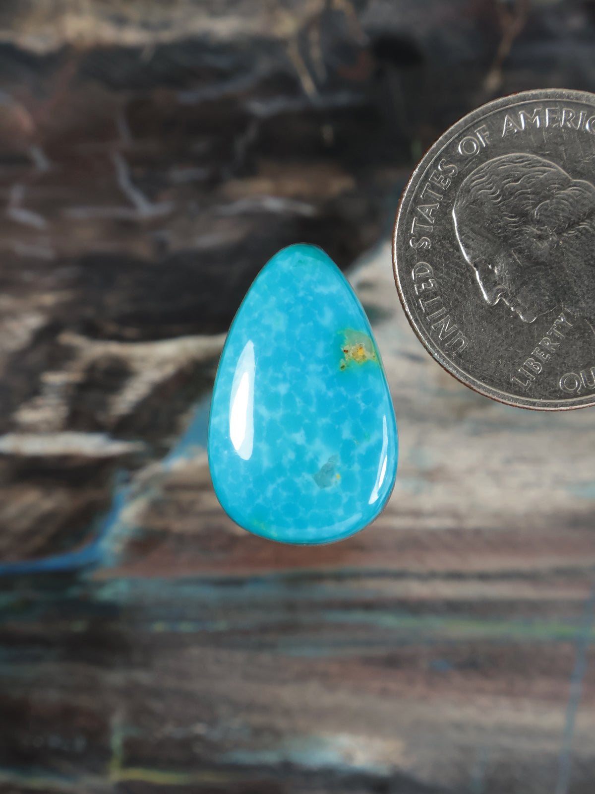 Turquoise teardrop cabochon with small gold accent