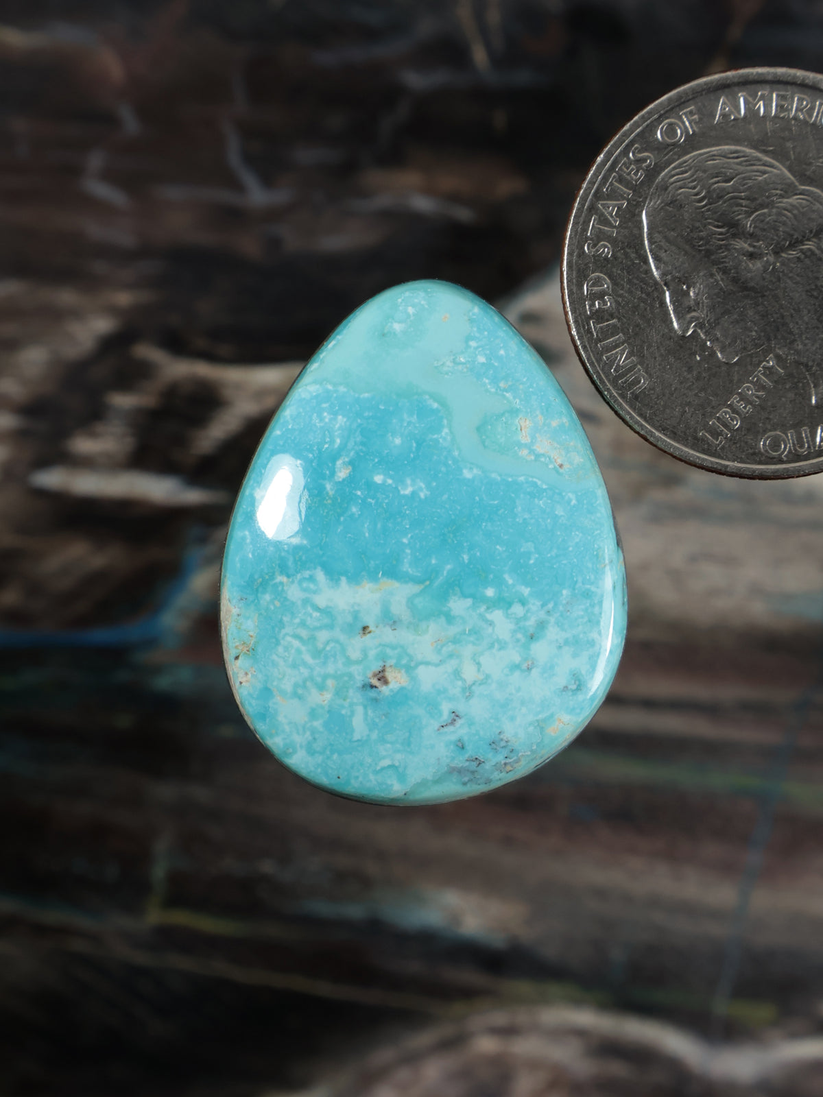 Turquoise cabochon gemstone, teardrop shape, polished blue-green stone