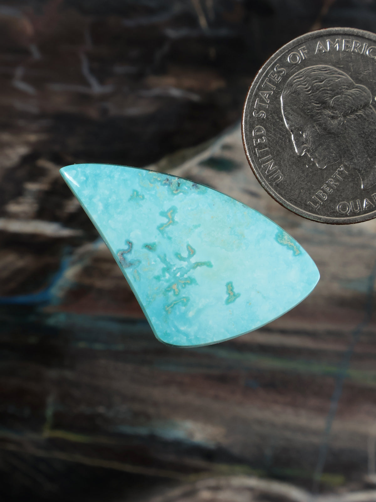 Turquoise cabochon stone, elongated triangle shape, light aqua with green flecks