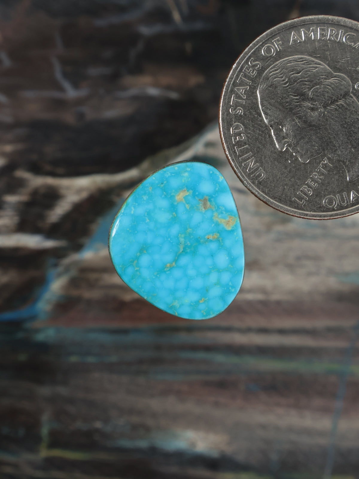 Oval turquoise gemstone cabochon with yellow veining