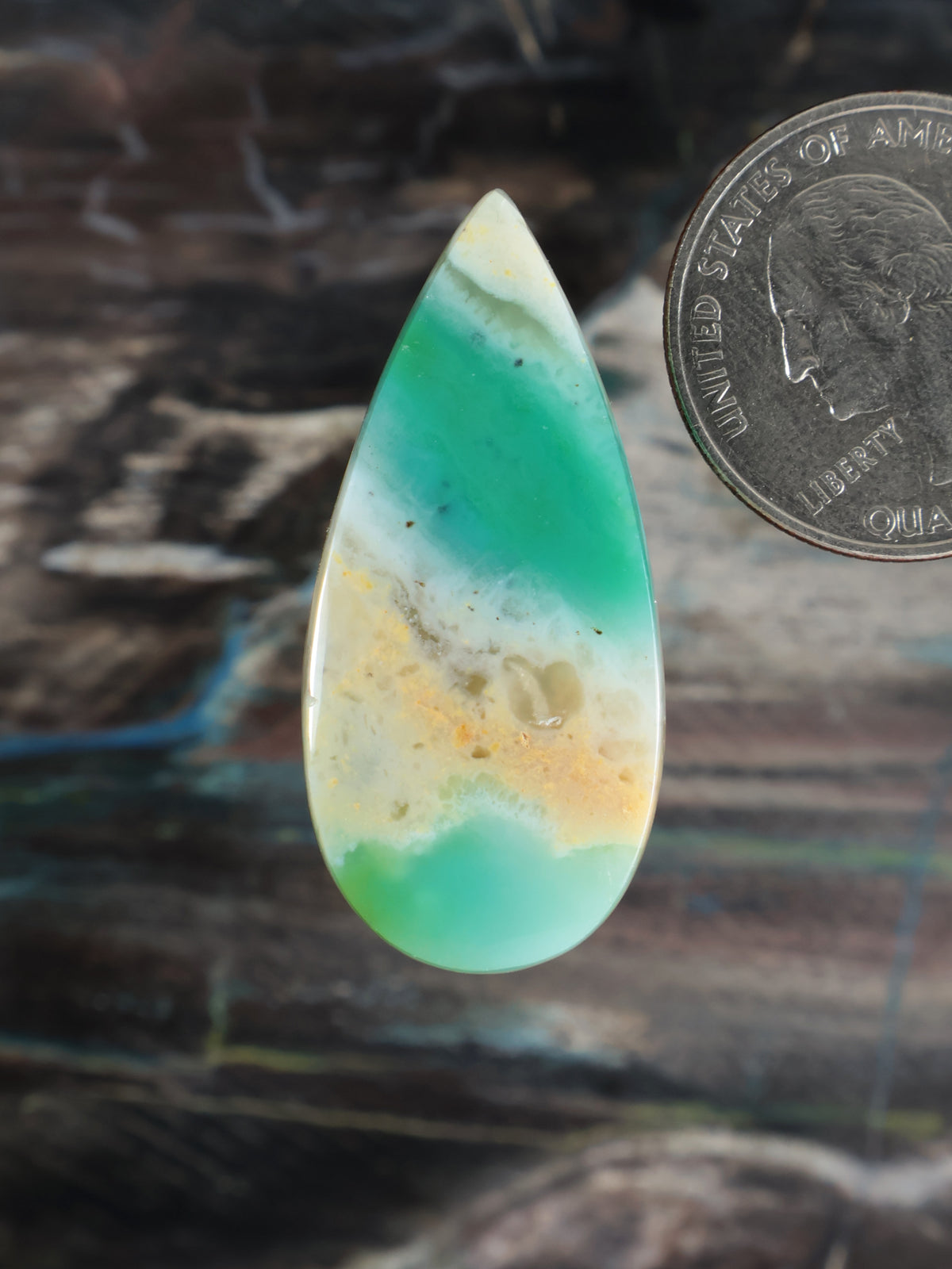 Teardrop opalized petrified wood cabochon, translucent green-blue with yellow matrix