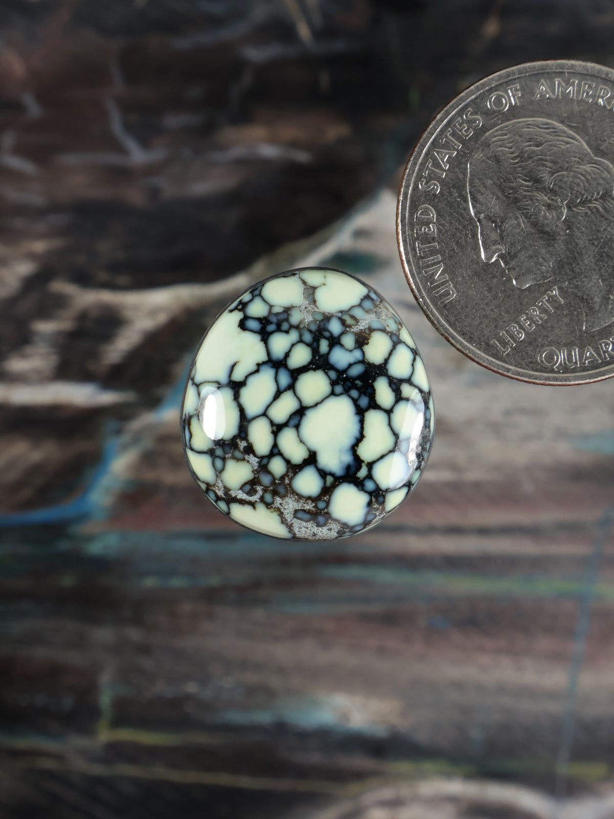 Round variscite cabochon with pale blue base and white veining, no setting