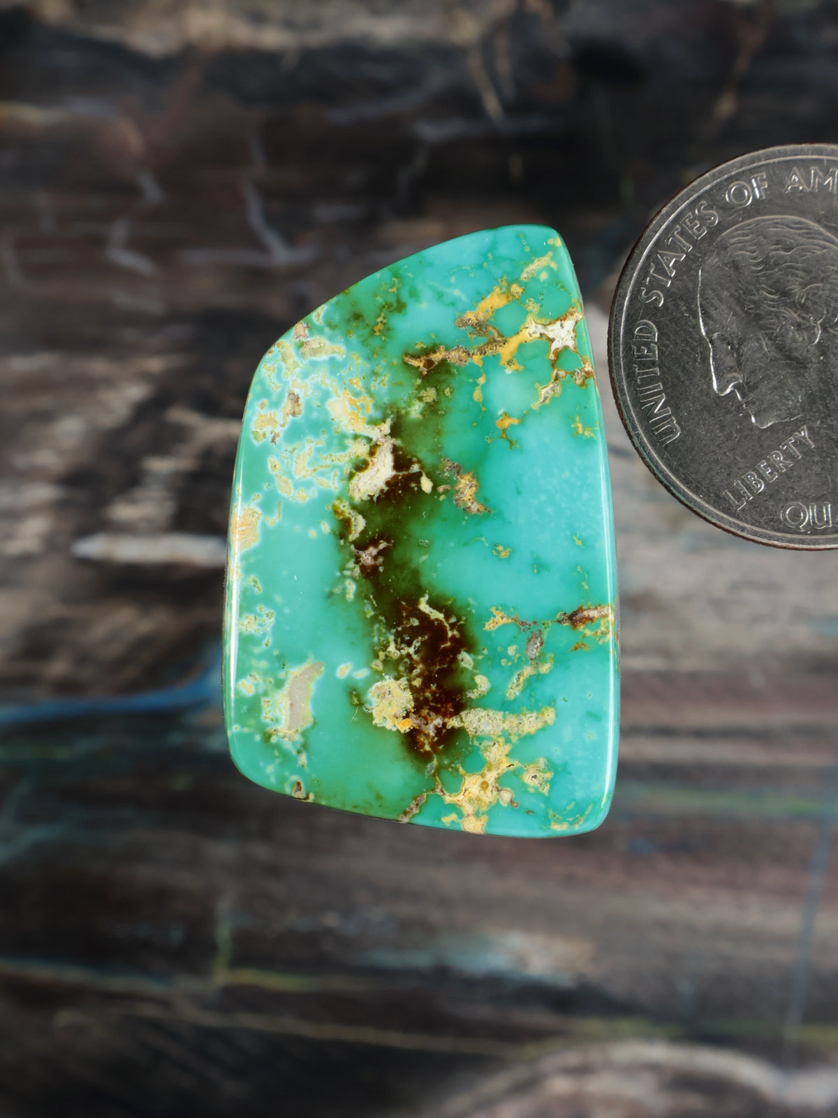 Turquoise cabochon gemstone with brown matrix veins, teardrop cut