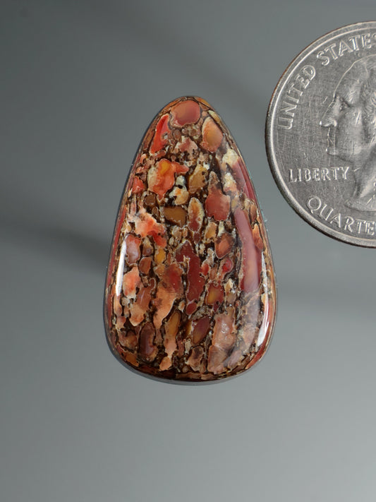 Dinosaur gembone cabochon, teardrop oval with red-brown and orange stone pattern