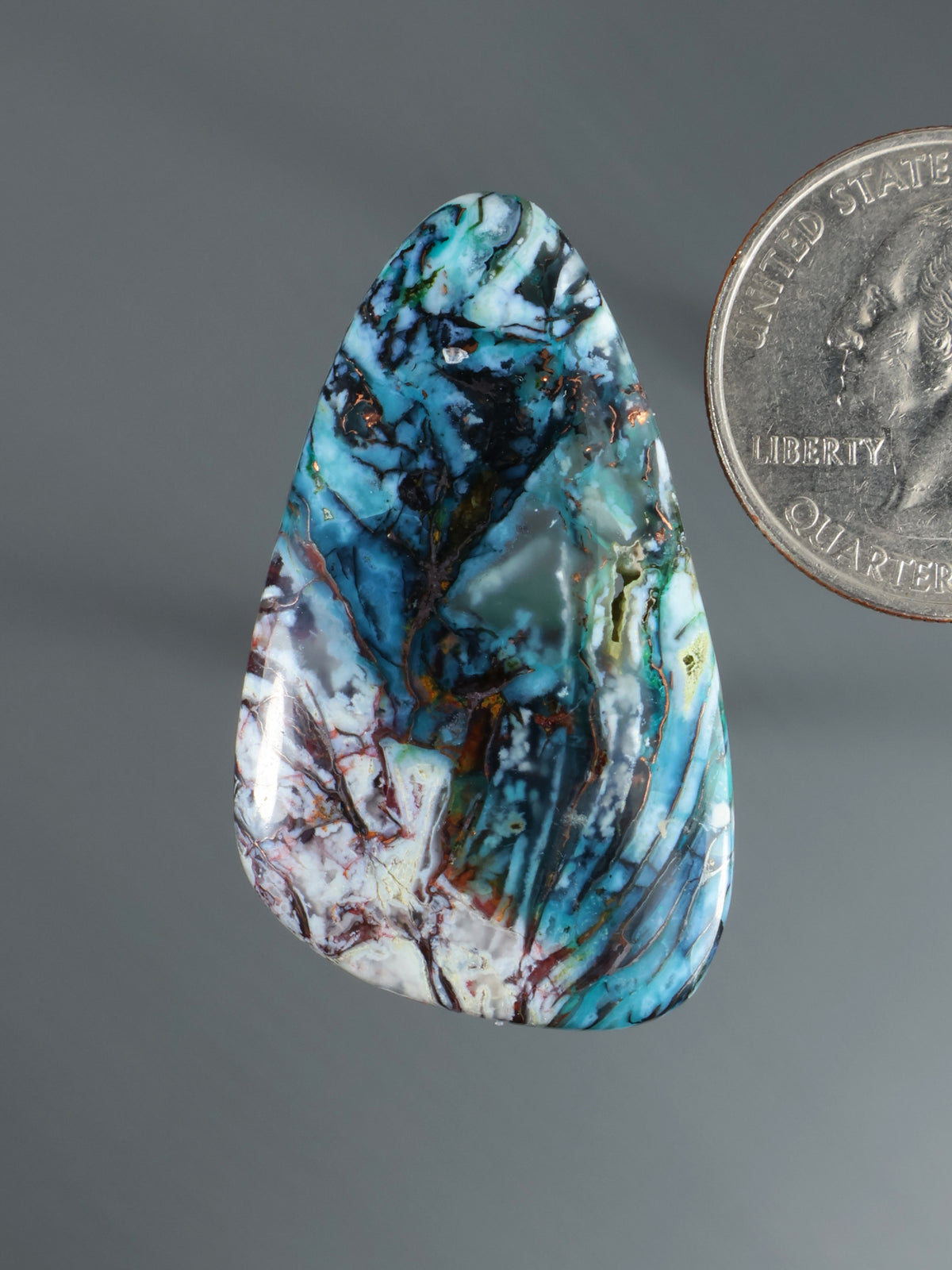 Blue-green marbled cabochon gemstone, teardrop oval with swirled veining
