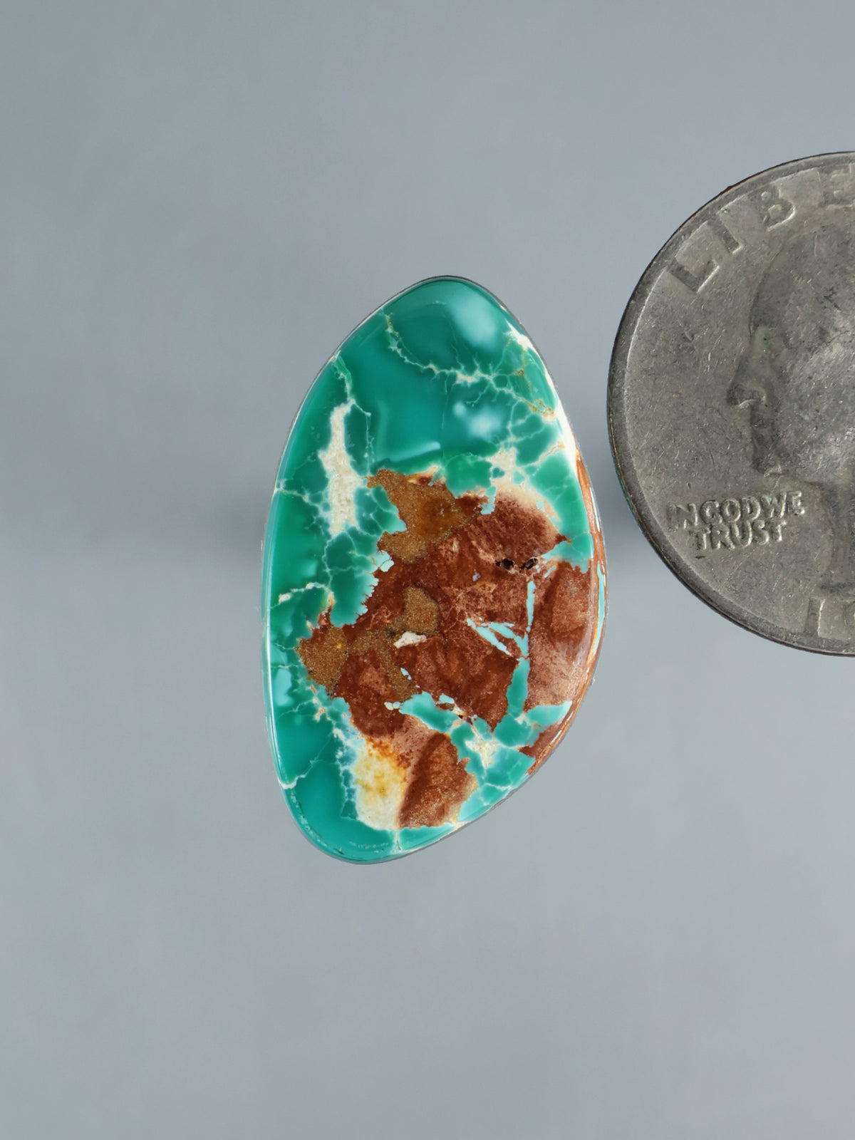 Royston blue turquoise oval cabochon with brown matrix veining