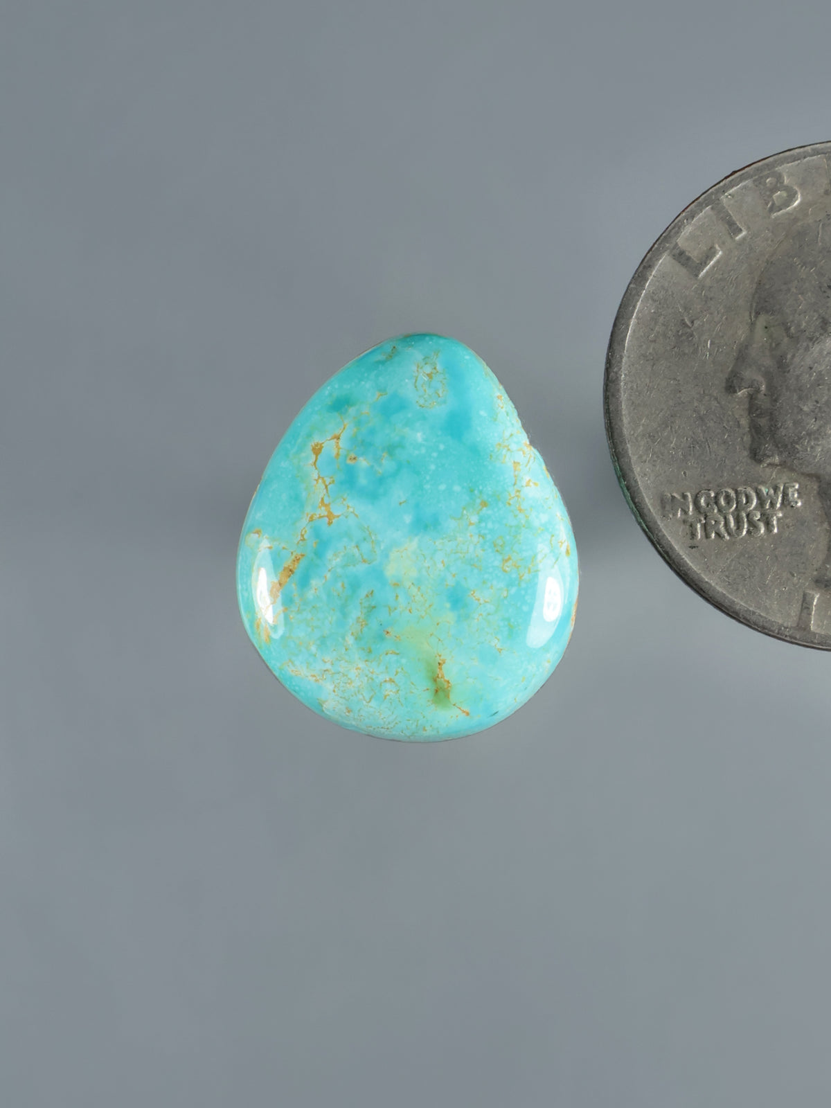 Turquoise oval cabochon gemstone with natural matrix veining