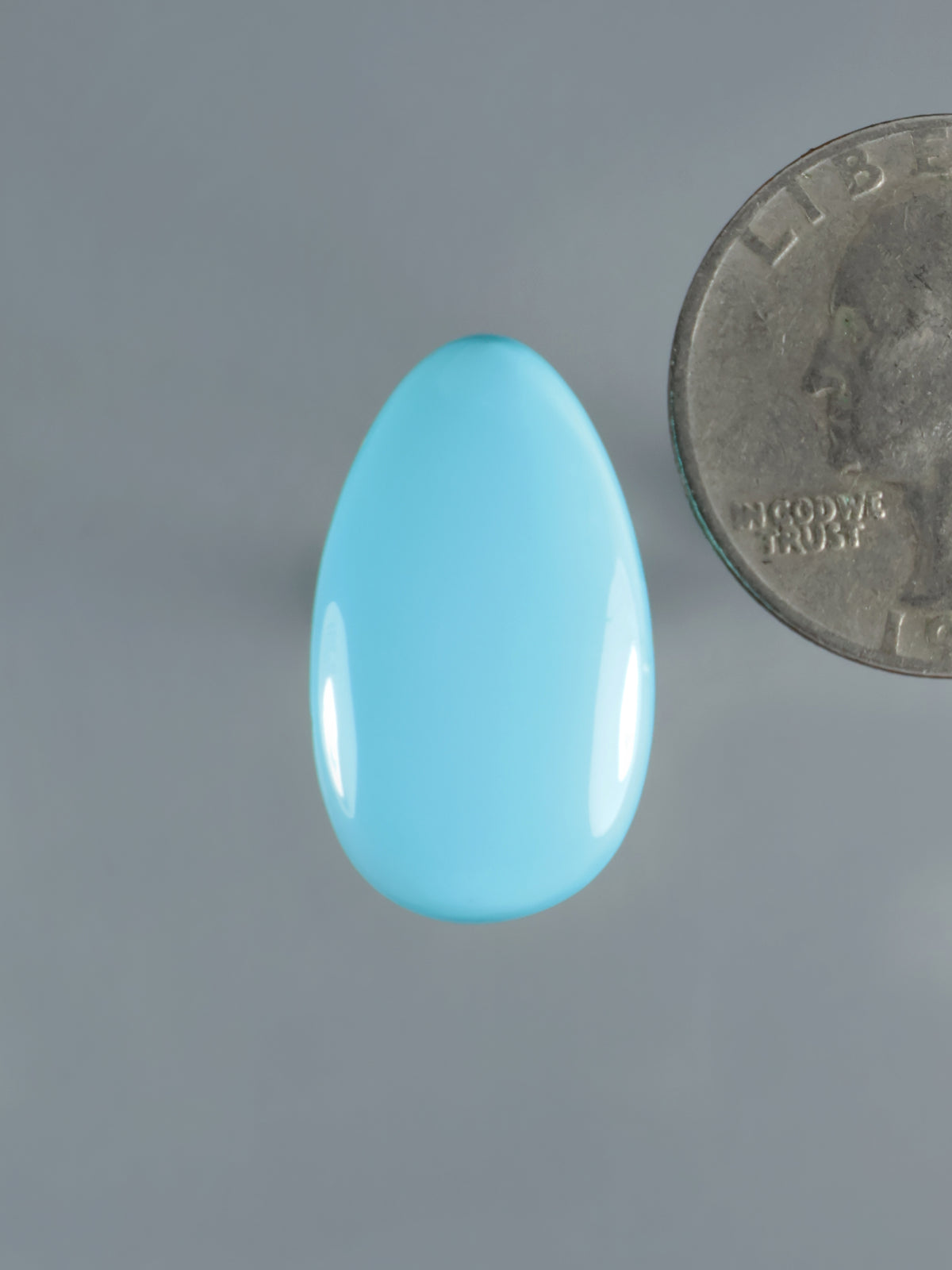 Turquoise oval cabochon gemstone with smooth polished surface