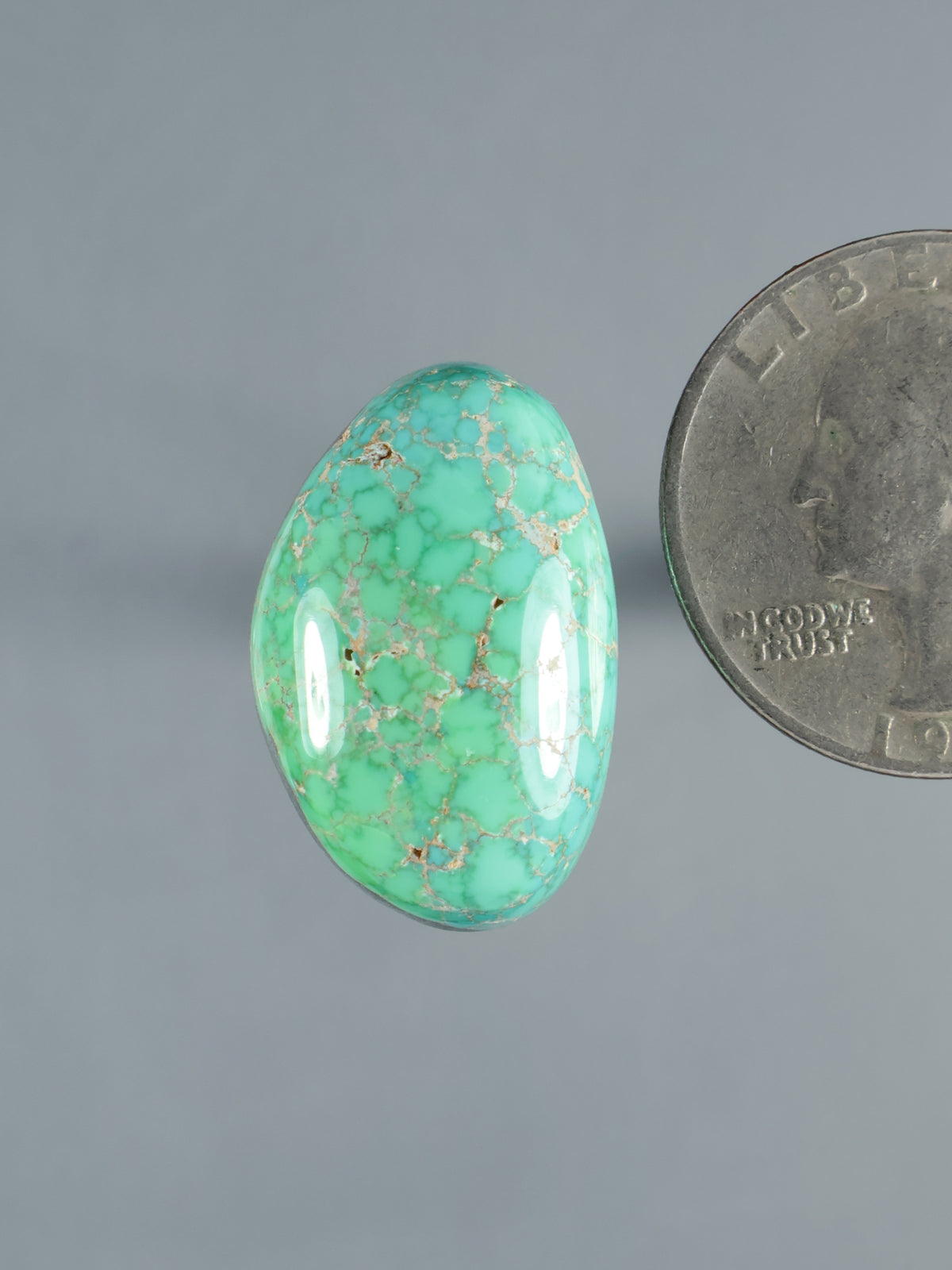 Teardrop turquoise cabochon gemstone, green-blue with natural matrix veining, polished