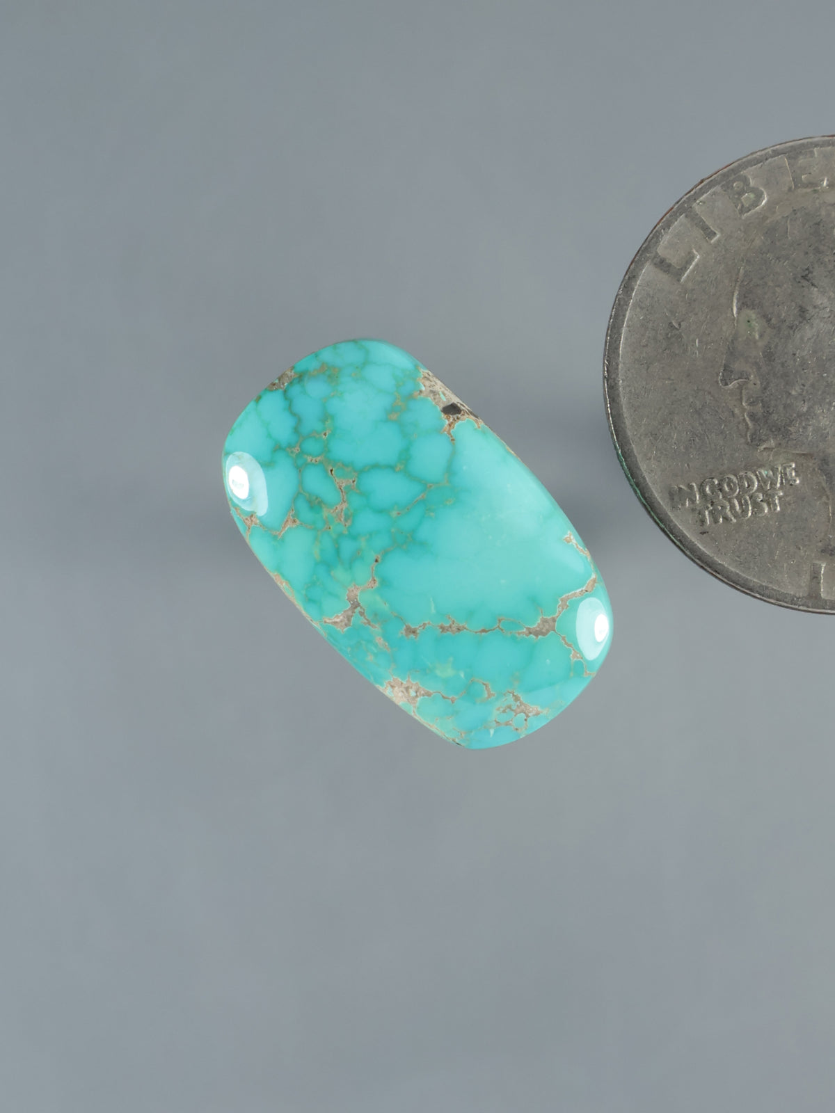 Turquoise cabochon gemstone, oval teardrop shape with web-like turquoise matrix, glossy