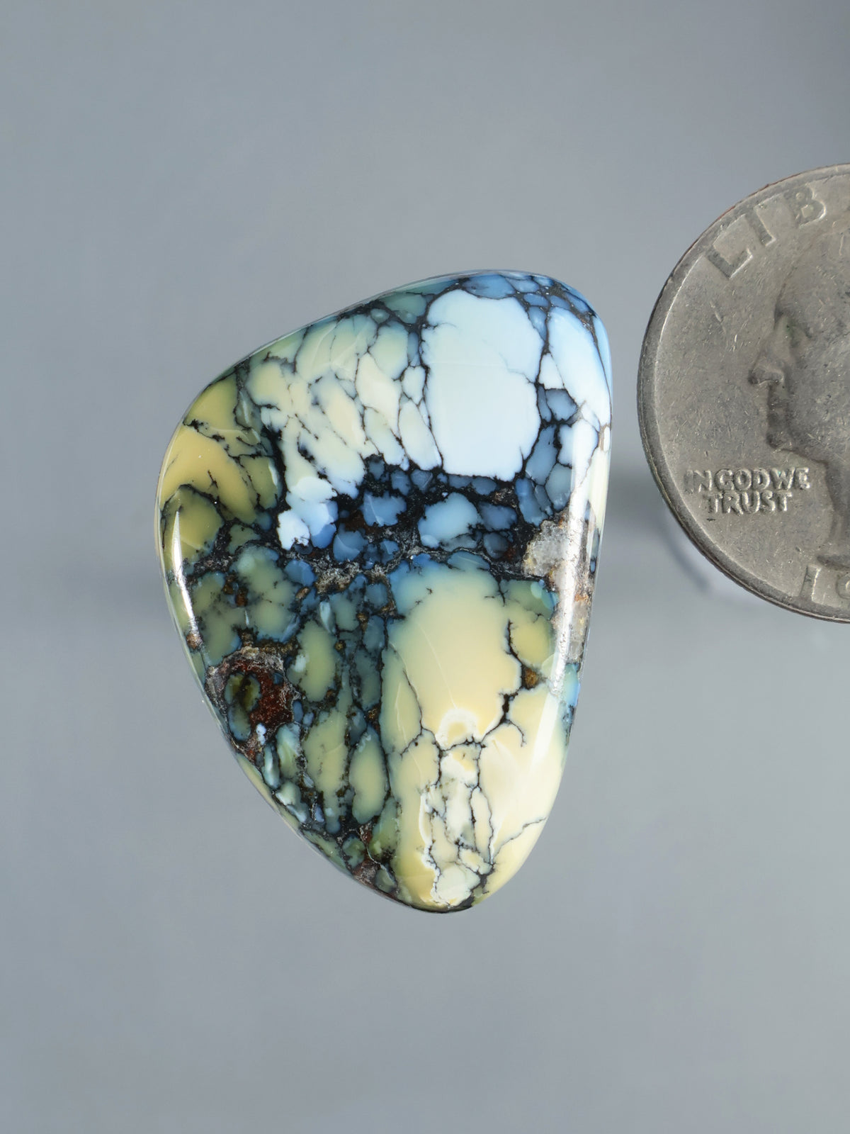 Wild Blue Cabochon B924, polished blue and cream stone with dark veining