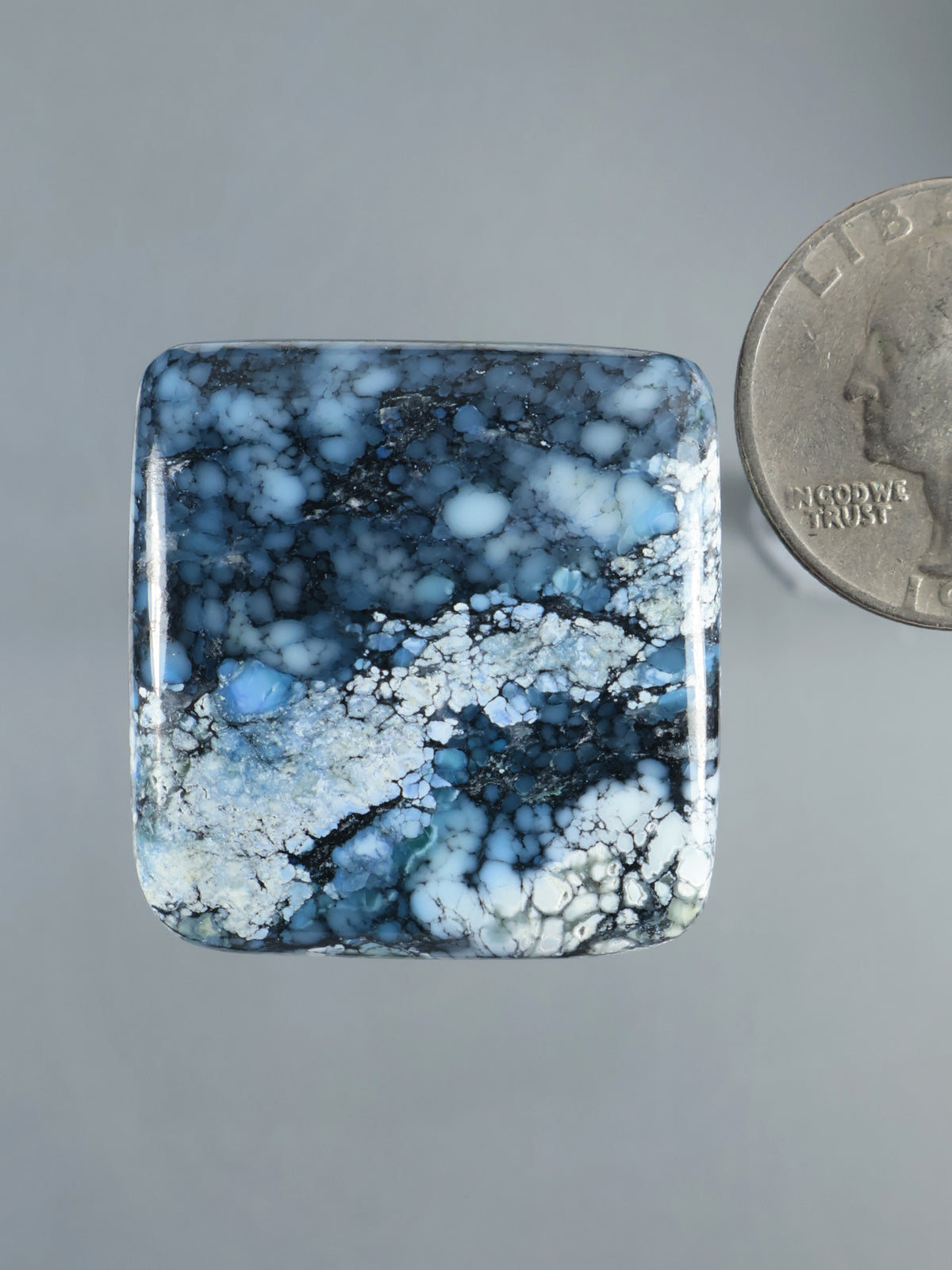 Square blue cabochon with dark and white mottled veining