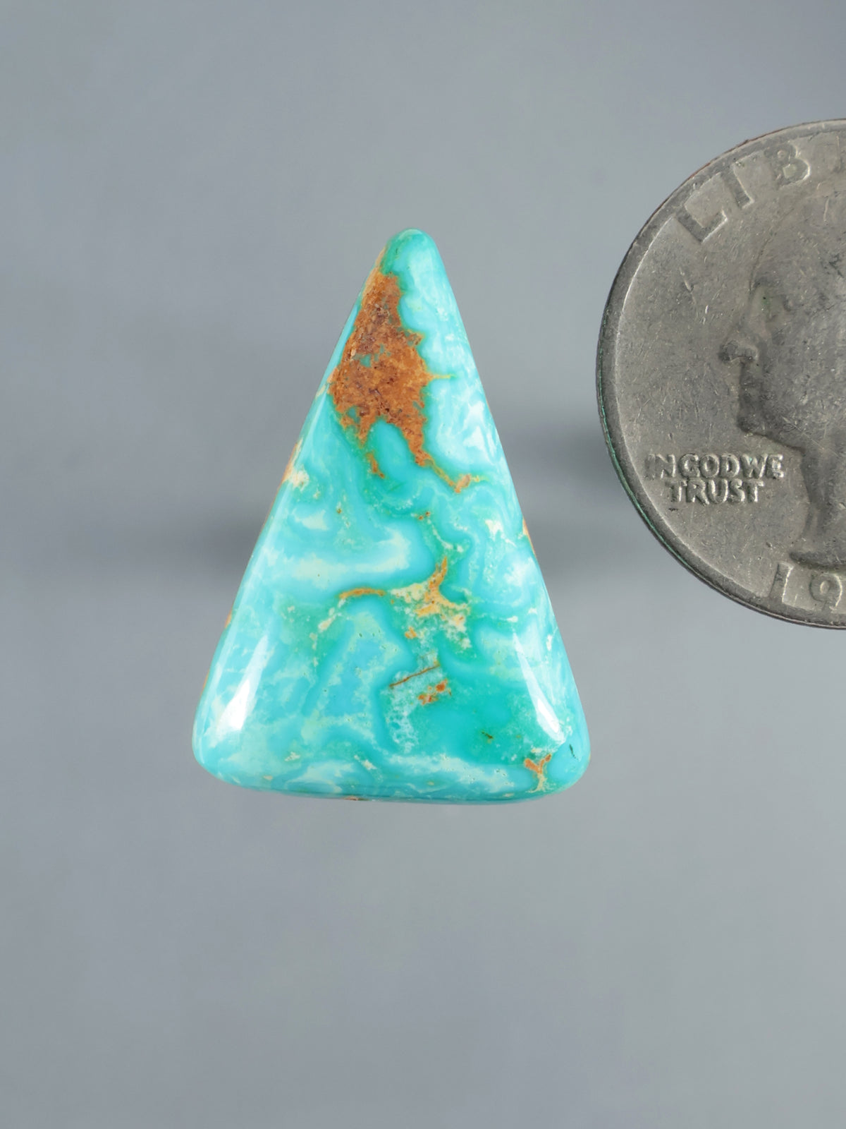 Hubei turquoise cabochon with triangular shape and rust-colored matrix veining