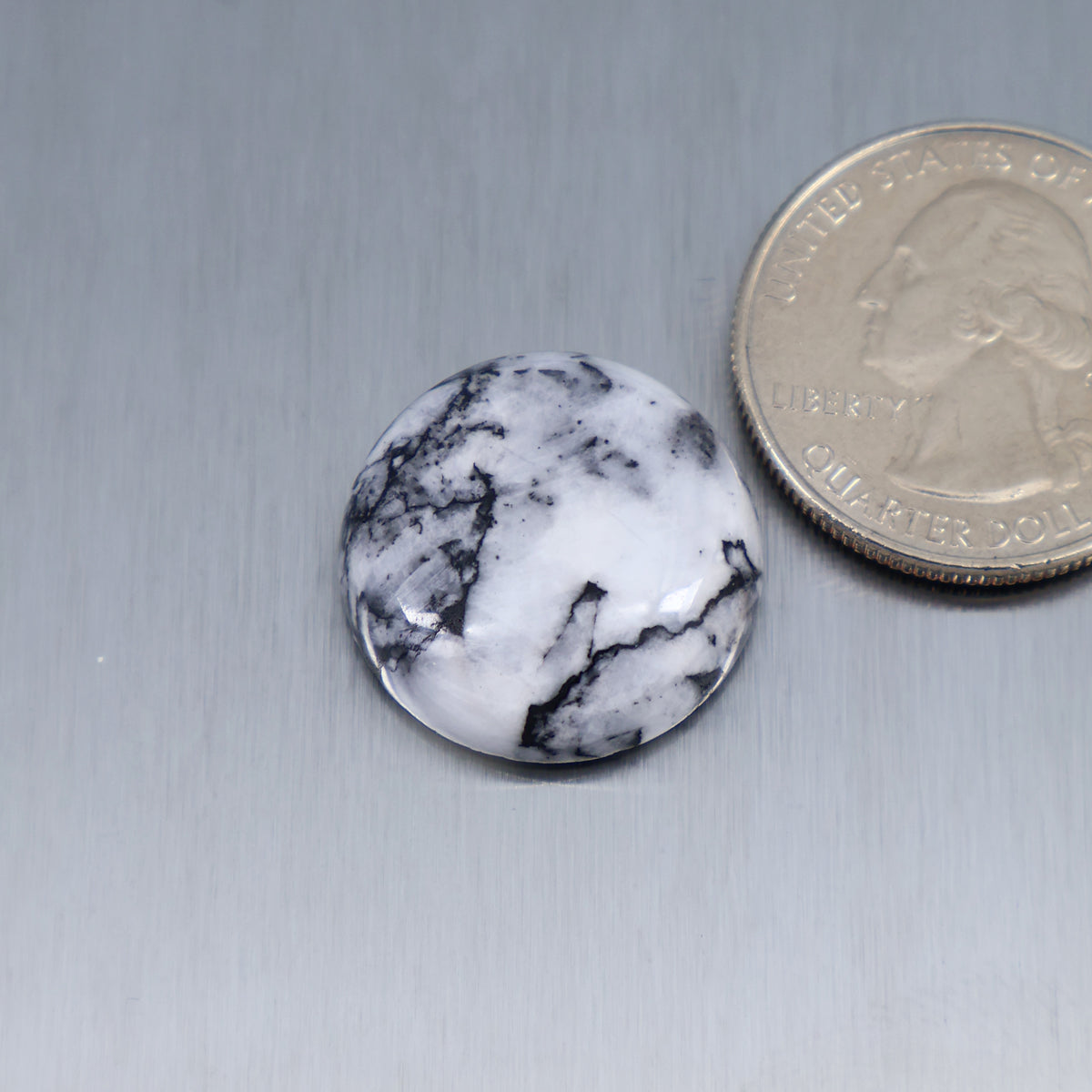 White feather cabochon, round gemstone with black veining pattern